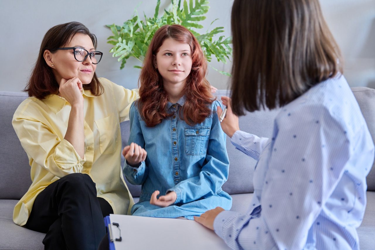 Child psychologist session mother daughter therapist together in office.jpg