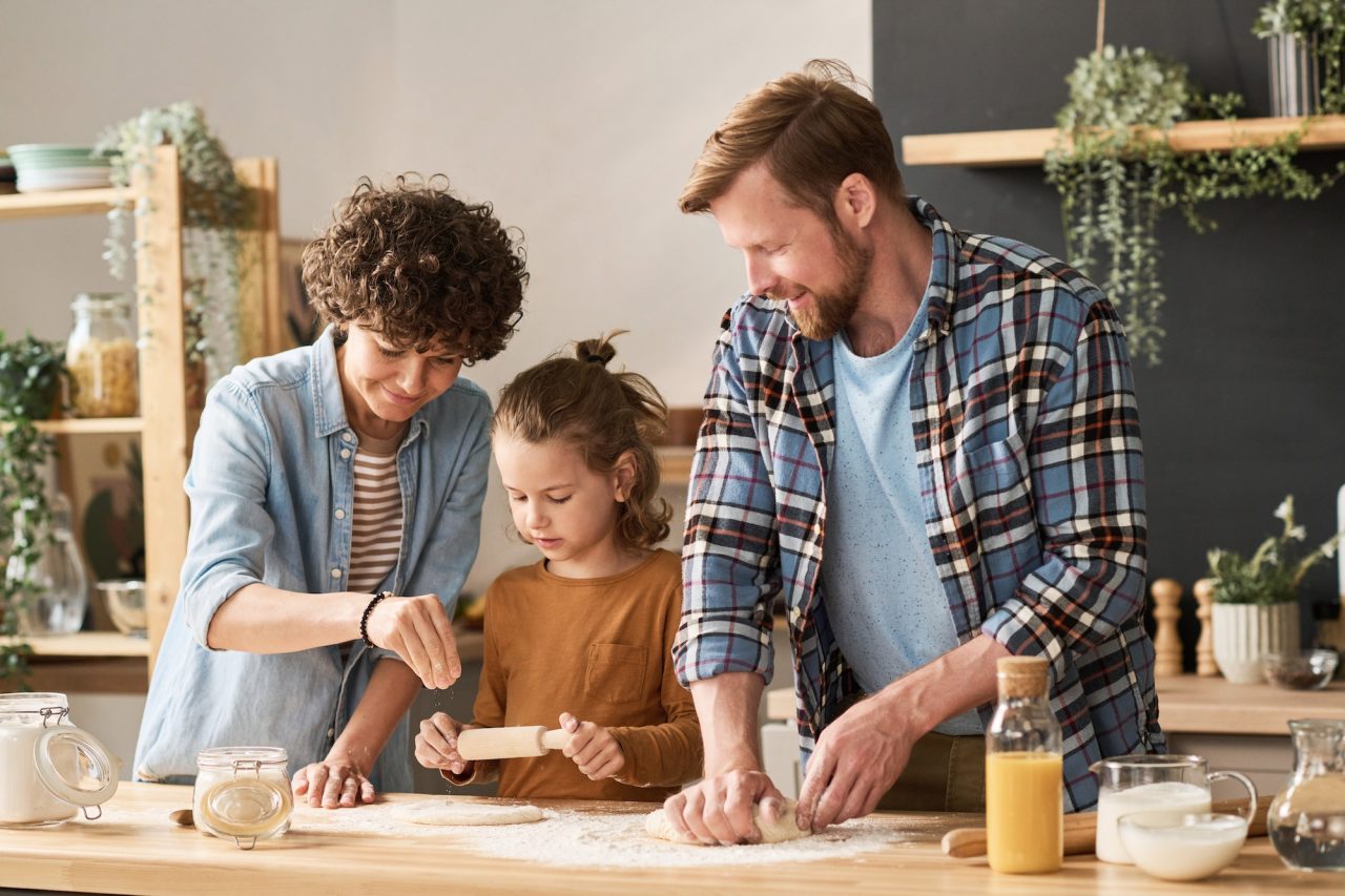 Parents teaching child to bake pie.jpg